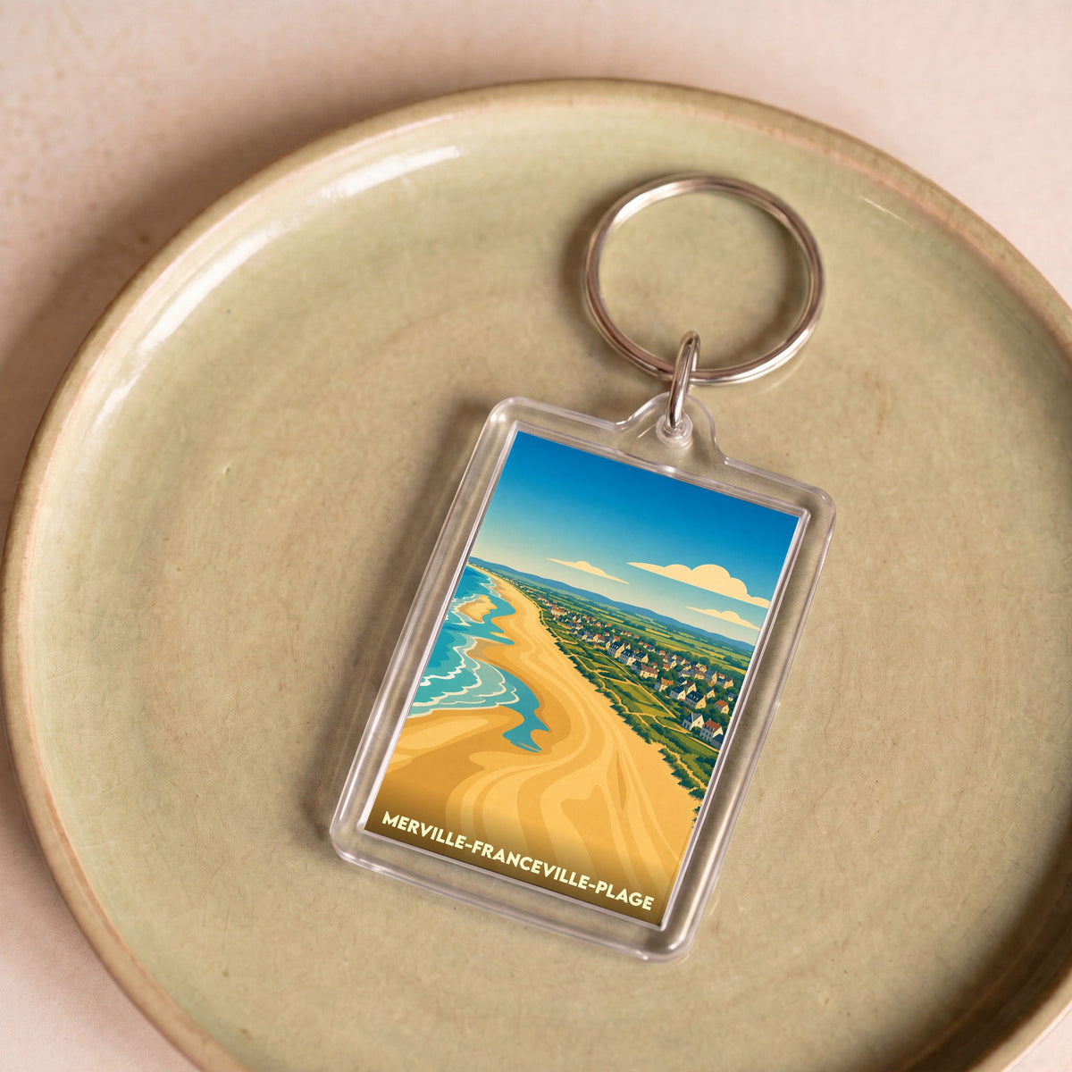 Porte-clés souvenir de Merville-Franceville-Plage orné d'une illustration stylisée de sa plage.
