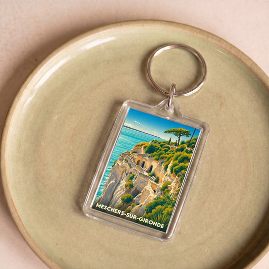 Porte-clés souvenir de Meschers-sur-Gironde illustrant les falaises et grottes troglodytiques en bord de mer.