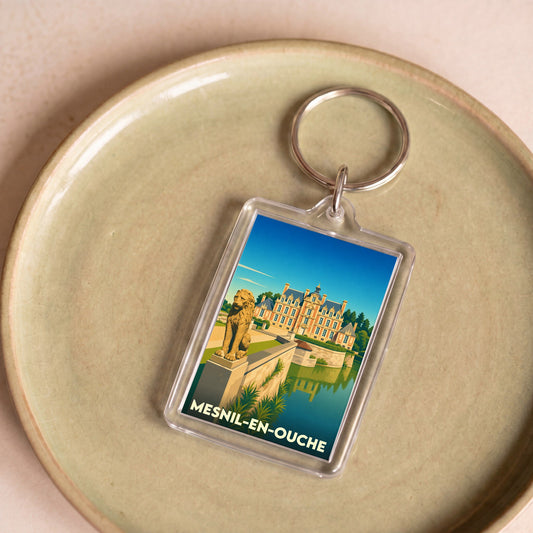 Porte-clés souvenir de la commune de Mesnil-en-Ouche avec une illustration stylisée de son château.