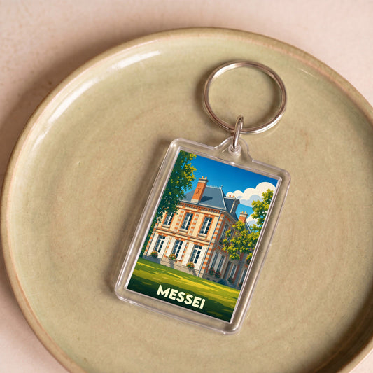 Porte-clés souvenir de la ville de Messei avec une illustration stylisée de son château.