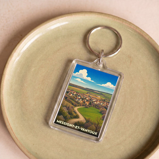Porte-clés souvenir de la ville de Messigny-et-Vantoux avec une illustration stylisée de son paysage.