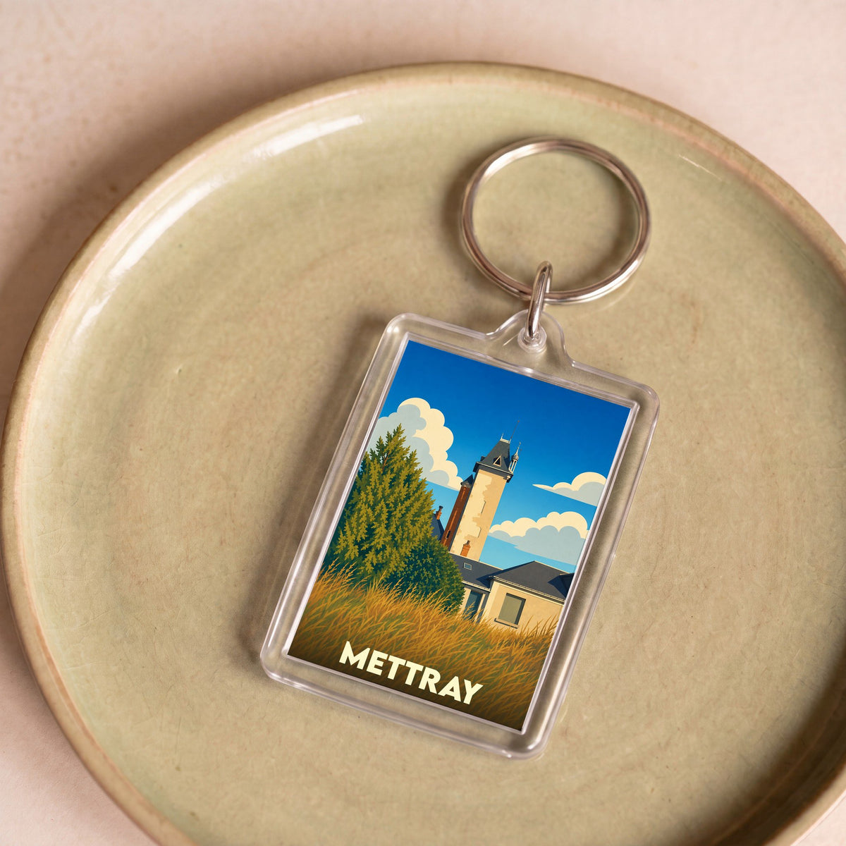 Porte-clés souvenir de la ville de Mettray avec une illustration stylisée.