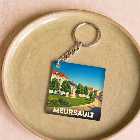 Porte-clés souvenir de la ville de Meursault avec une illustration stylisée.
