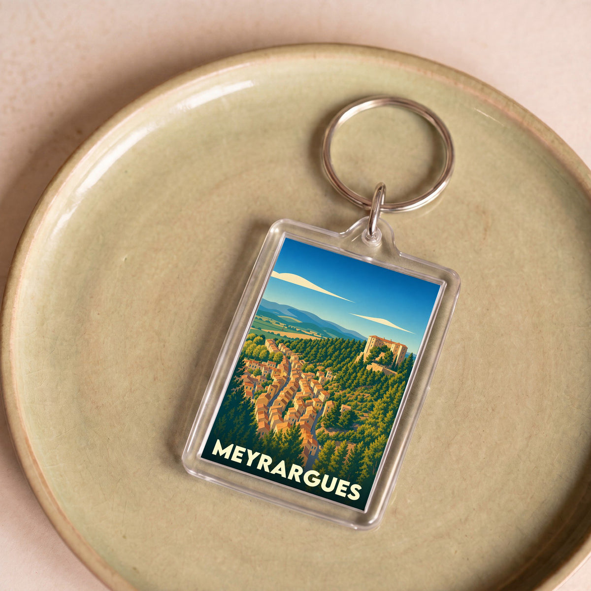 Porte-clés souvenir de la ville de Meyrargues avec une illustration stylisée.