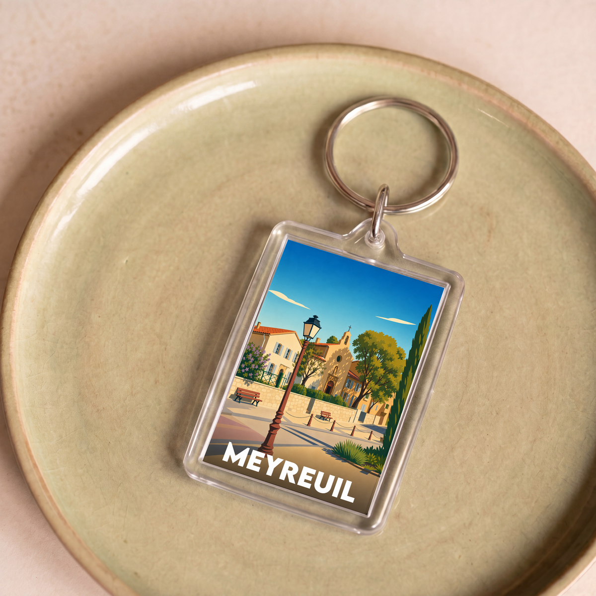 Porte-clés souvenir de la ville de Meyreuil avec une illustration stylisée.