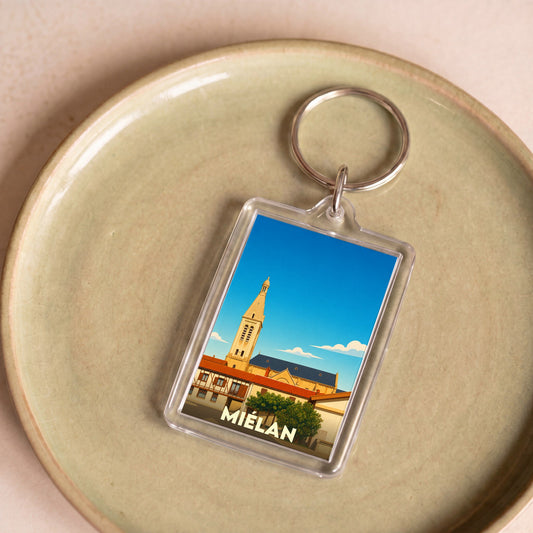Porte-clés souvenir de la ville de Miélan avec une illustration stylisée.