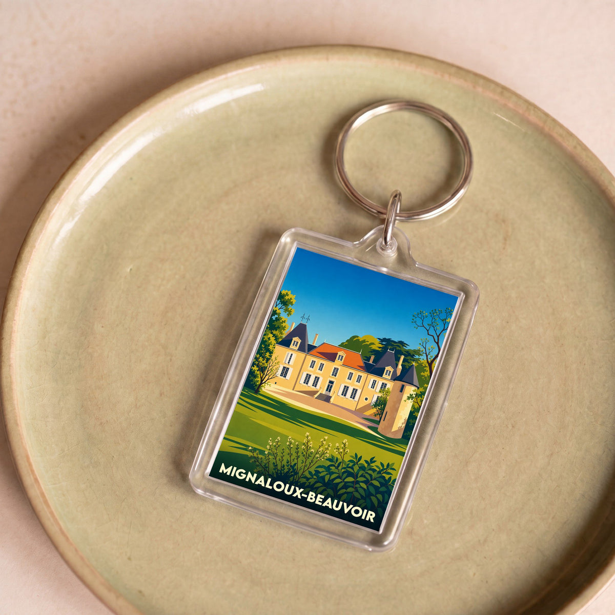 Porte-clés souvenir de la ville de Mignaloux-Beauvoir avec une illustration stylisée d'un château.