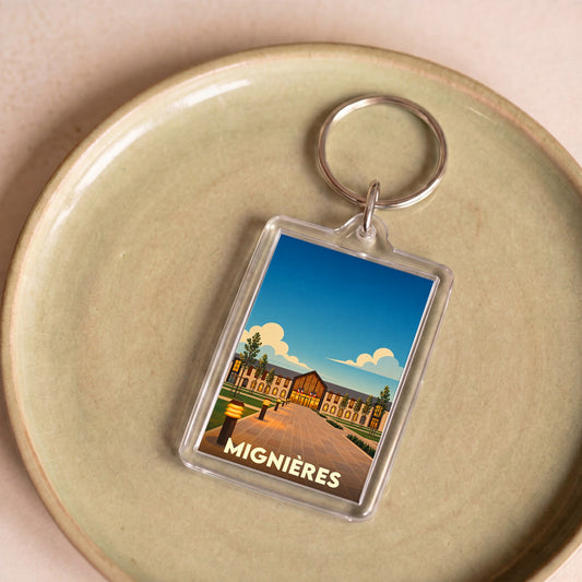 Porte-clés souvenir de la ville de Mignières avec une illustration stylisée.