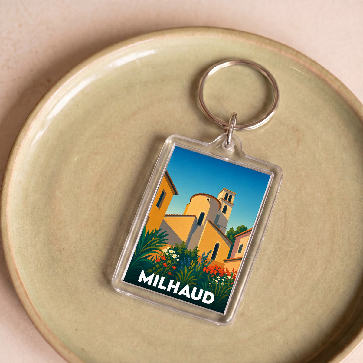 Porte-clés souvenir de la ville de Milhaud avec une illustration stylisée.