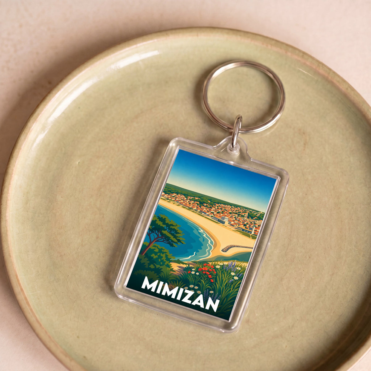 Porte-clés souvenir de la ville de Mimizan avec une illustration colorée de la côte landaise.
