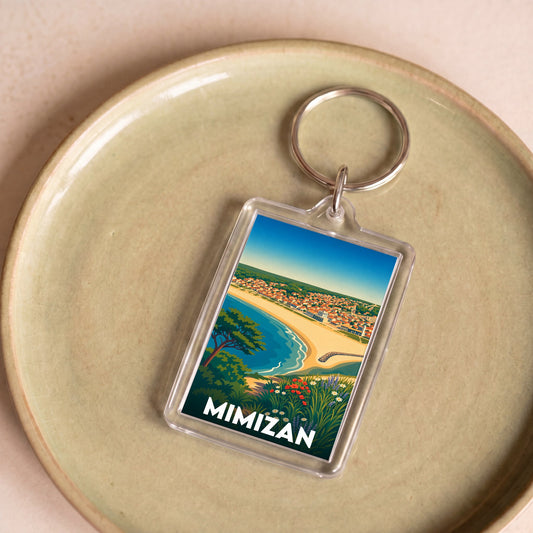 Porte-clés souvenir de la ville de Mimizan avec une illustration colorée de la côte landaise.