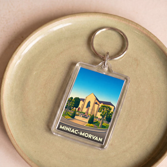 Porte-clés souvenir de la ville de Miniac-Morvan avec une illustration stylisée.