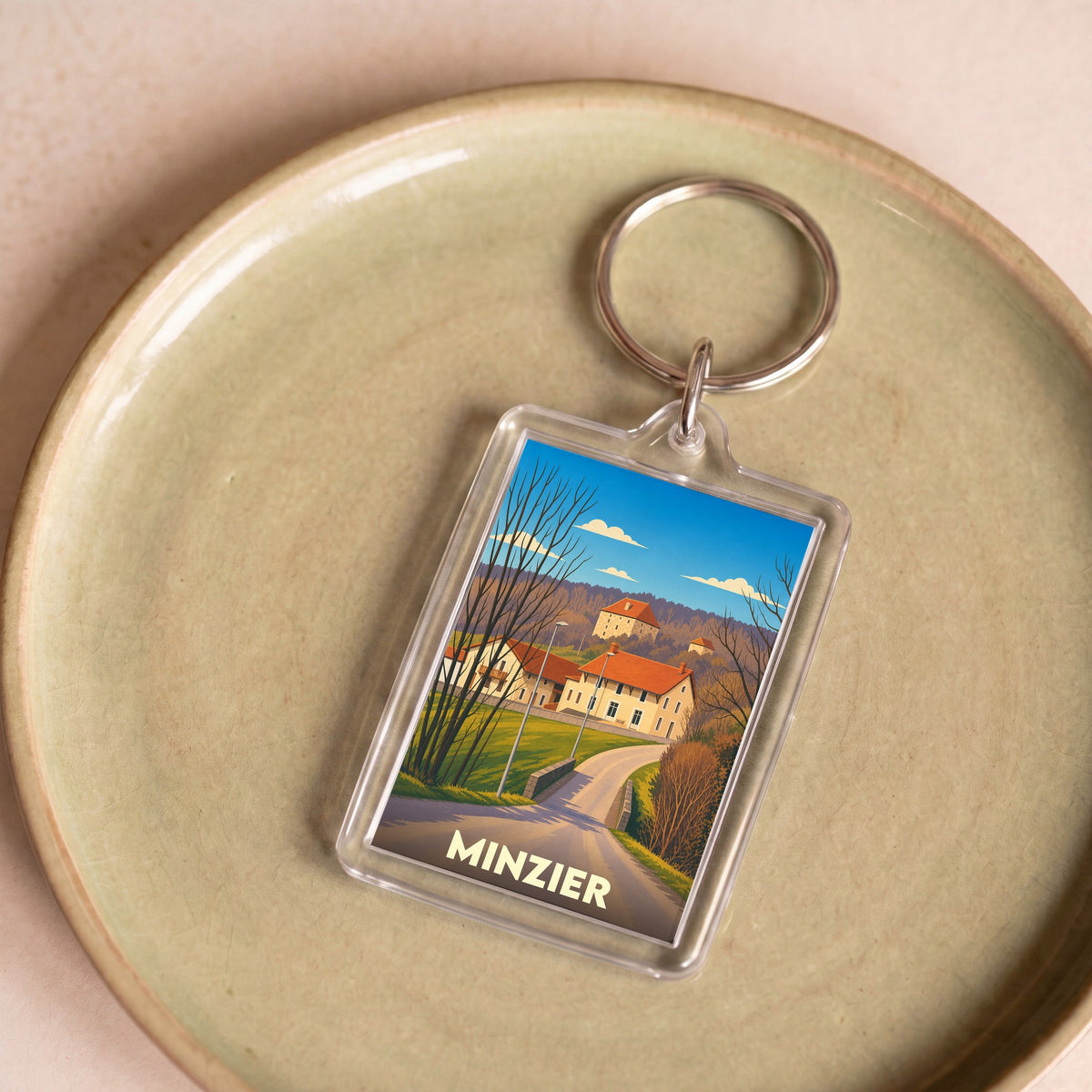 Porte-clés souvenir de la ville de Minzier avec une illustration stylisée.