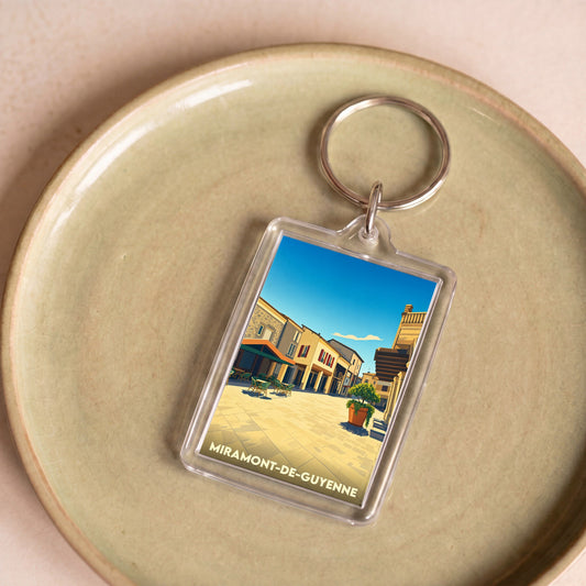 Porte-clés souvenir de la ville de Miramont-de-Guyenne avec une illustration stylisée.