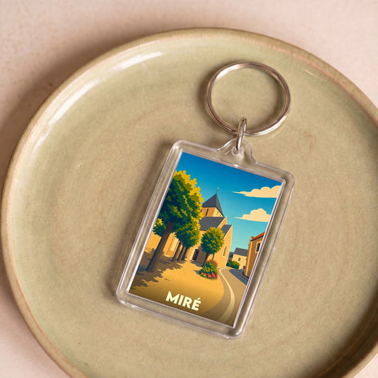 Porte-clés souvenir de la ville de Miré avec une illustration stylisée et colorée.