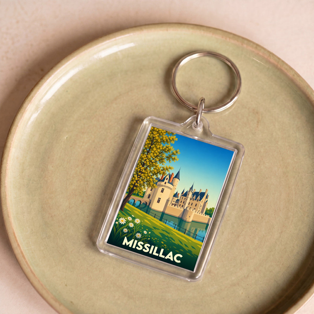 Porte-clés souvenir de la ville de Missillac avec une illustration stylisée de son château.