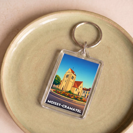 Porte-clés souvenir de la ville de Moissy-Cramayel avec une illustration stylisée.