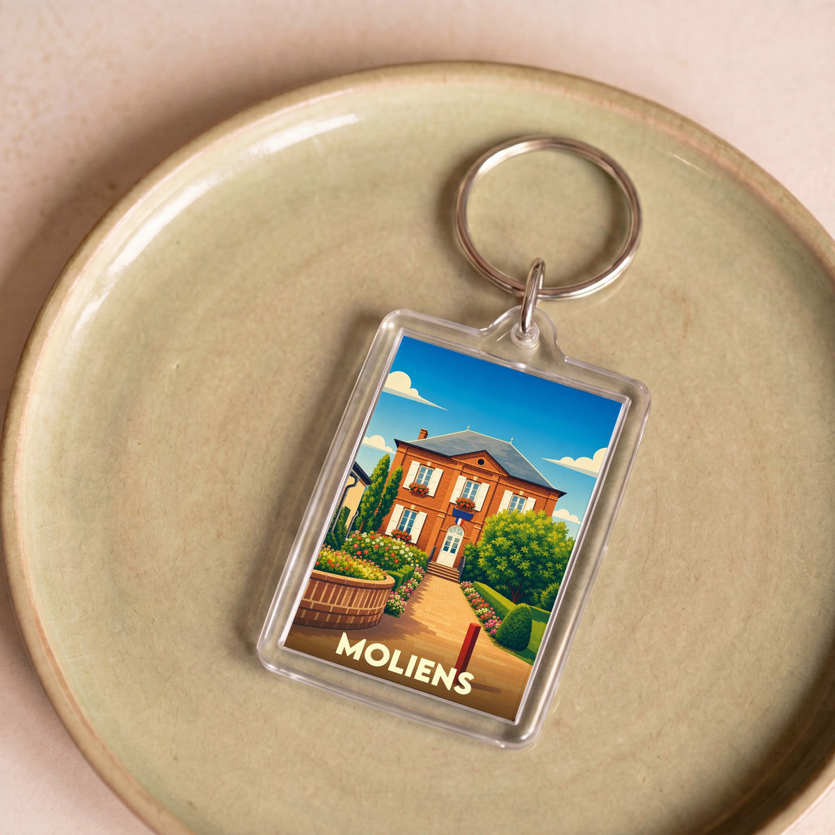 Porte-clés souvenir de la ville de Moliens avec une illustration stylisée de sa mairie.