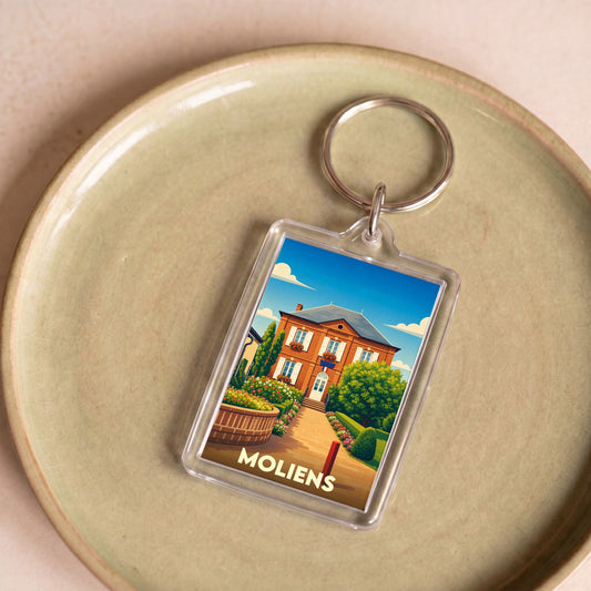 Porte-clés souvenir de la ville de Moliens avec une illustration stylisée de sa mairie.
