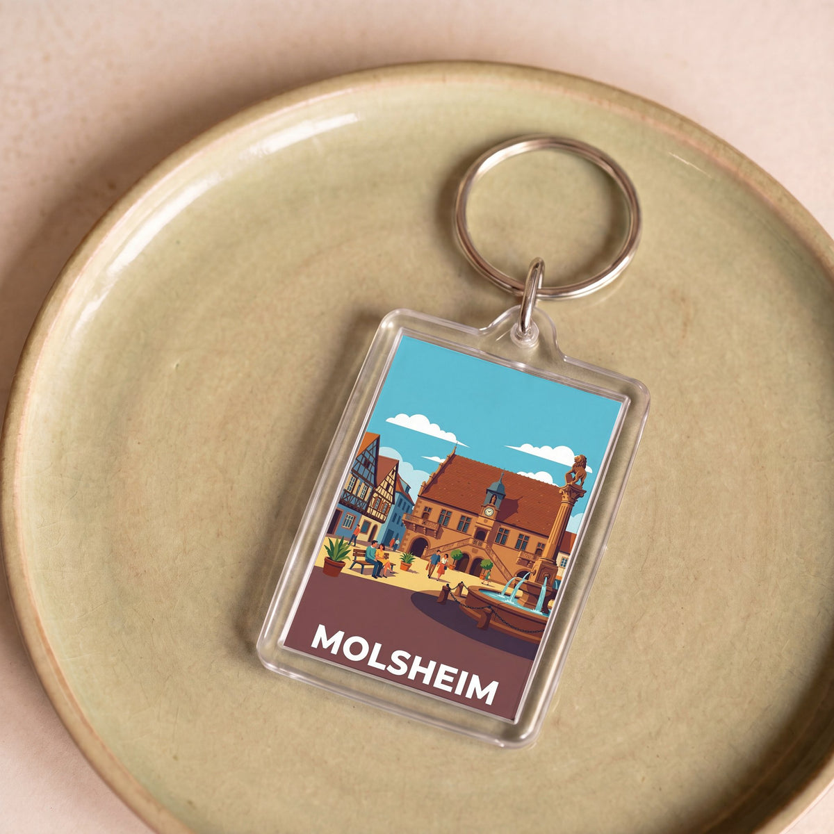 Porte-clés souvenir de la ville de Molsheim avec une illustration stylisée de son architecture historique.