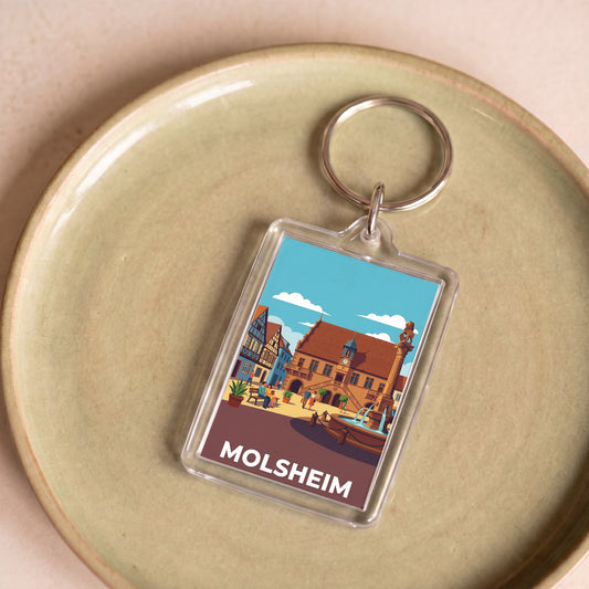Porte-clés souvenir de la ville de Molsheim avec une illustration stylisée de son architecture historique.