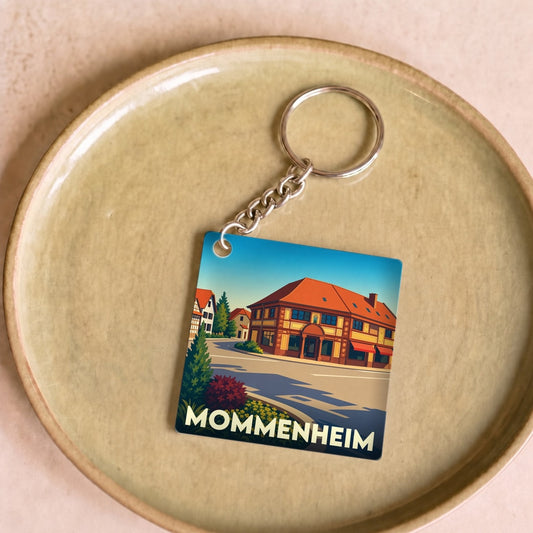 Porte-clés souvenir de la ville de Mommenheim avec une illustration stylisée.