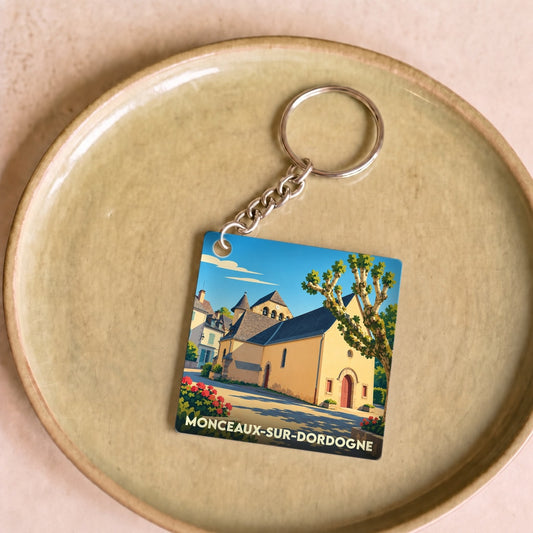 Porte-clés souvenir de la ville de Monceaux-sur-Dordogne avec une illustration stylisée.