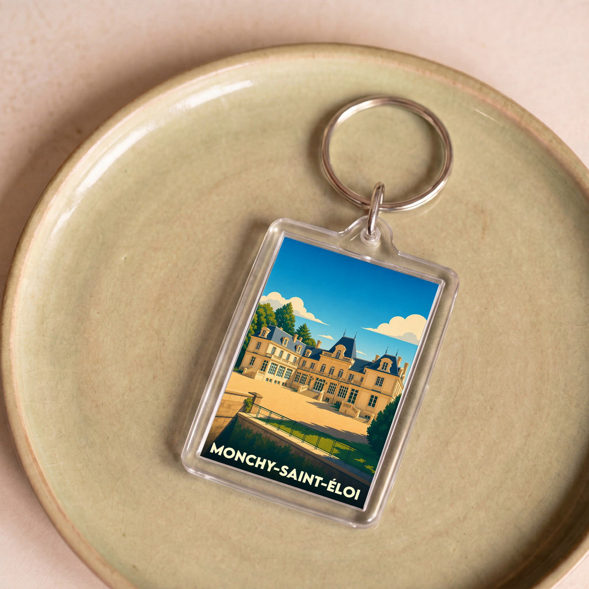 Porte-clés souvenir de la ville de Monchy-Saint-Éloi avec une illustration stylisée de son château.