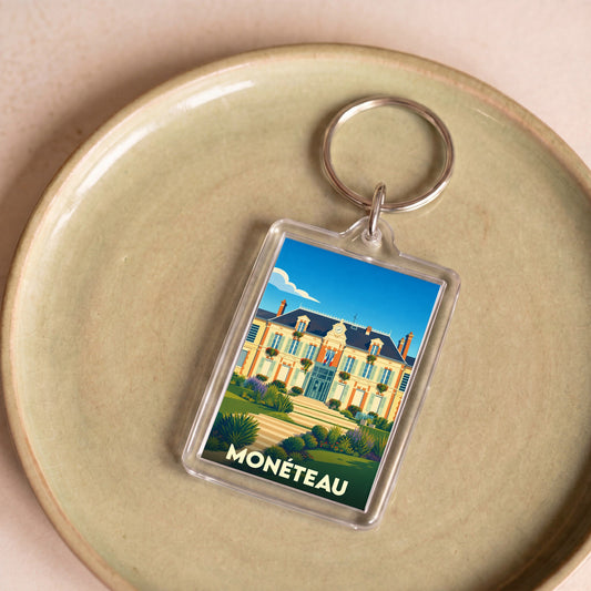 Porte-clés souvenir de la ville de Monéteau avec une illustration stylisée de la mairie.