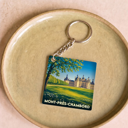 Porte-clés souvenir de la ville de Mont-près-Chambord avec une illustration stylisée du château de Chambord.