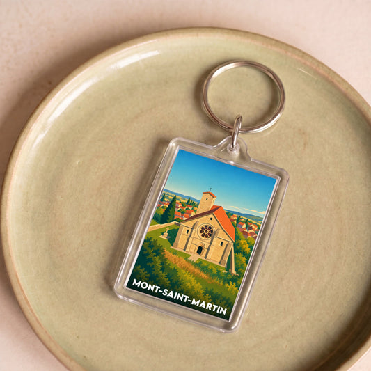 Porte-clés souvenir de la ville de Mont-Saint-Martin avec une illustration stylisée d'une église.