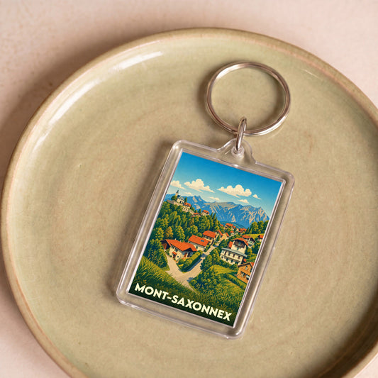 Porte-clés souvenir de la ville de Mont-Saxonnex avec une illustration stylisée de montagne.