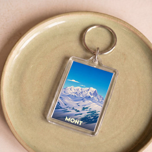 Porte-clés souvenir de la ville de Mont avec une illustration stylisée d'un paysage de montagne enneigé.
