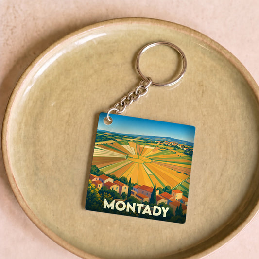 Porte-clés souvenir de la ville de Montady illustrant son célèbre étang asséché en forme de soleil.