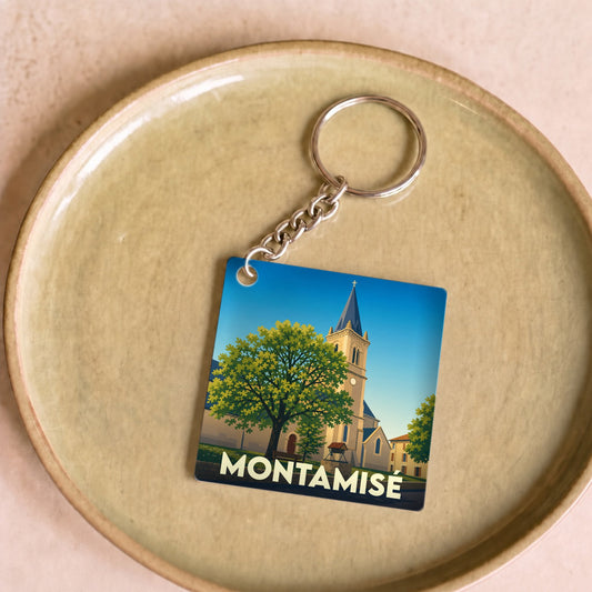 Porte-clés souvenir de la ville de Montamisé avec une illustration stylisée de son église et d'un grand arbre.