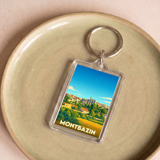 Porte-clés souvenir de la ville de Montbazin avec une illustration stylisée.