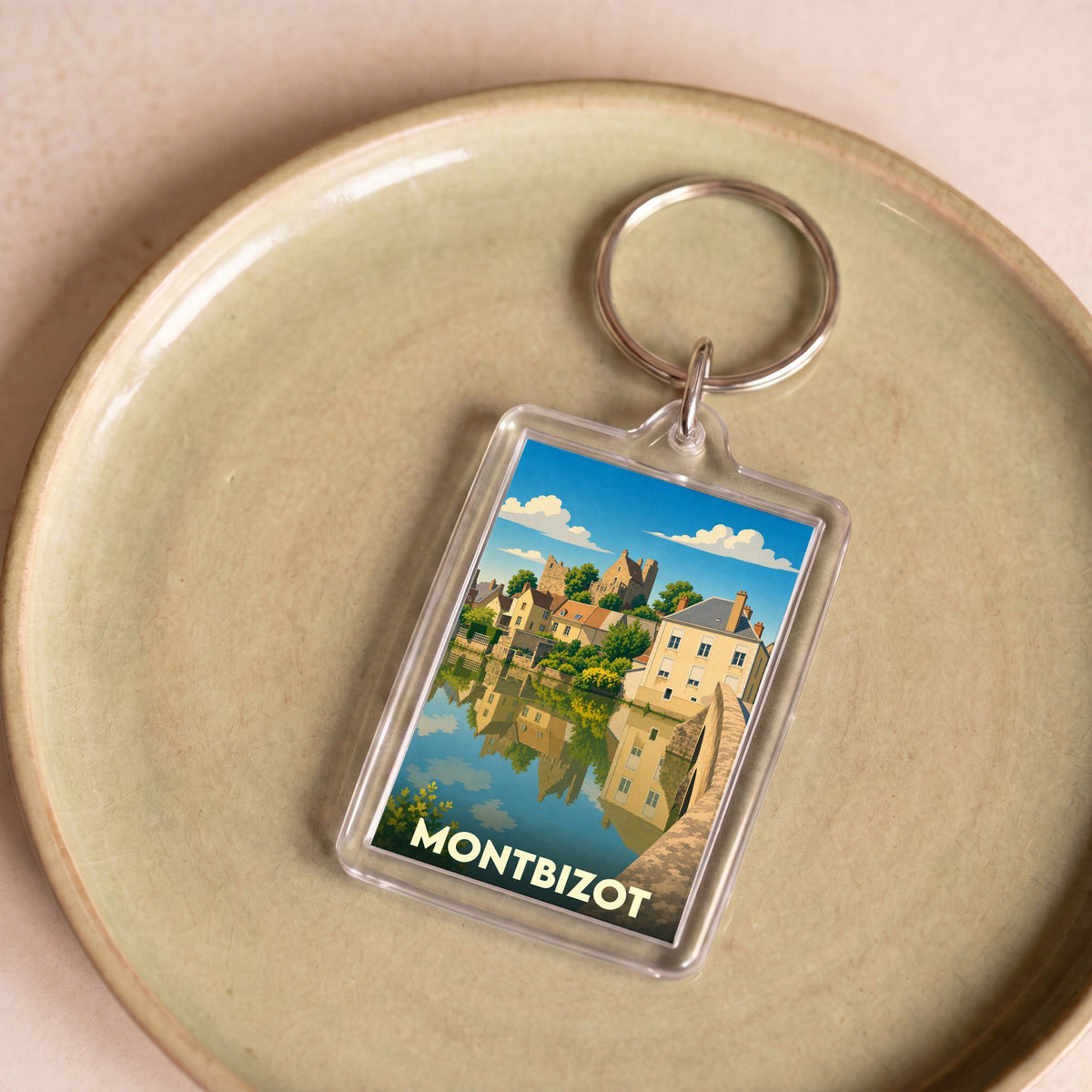 Porte-clés souvenir de la ville de Montbizot avec une illustration stylisée.