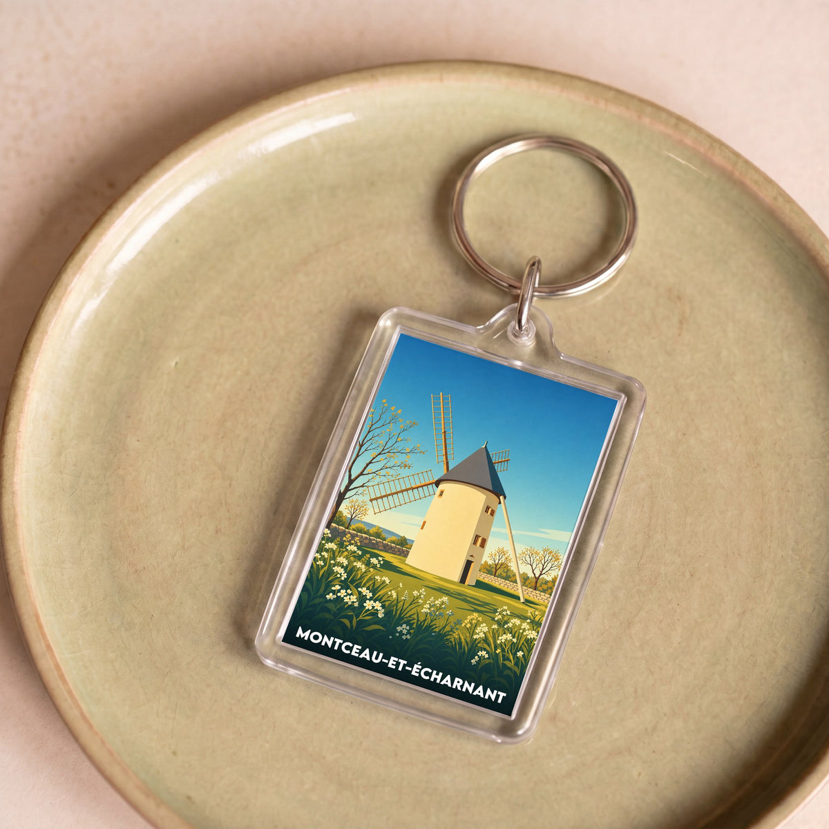 Porte-clés souvenir de la ville de Montceau-et-Écharnant avec une illustration stylisée d'un moulin.
