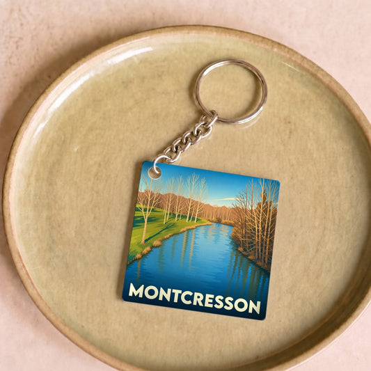 Porte-clés souvenir de la ville de Montcresson avec une illustration stylisée d'un paysage de rivière.
