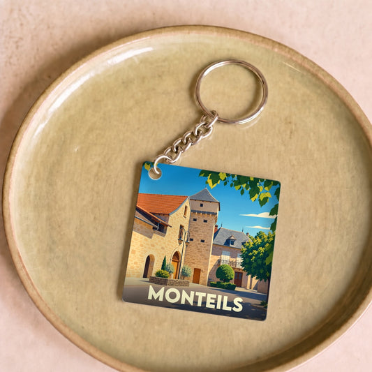 Porte-clés souvenir de la ville de Monteils avec une illustration stylisée de son architecture médiévale.