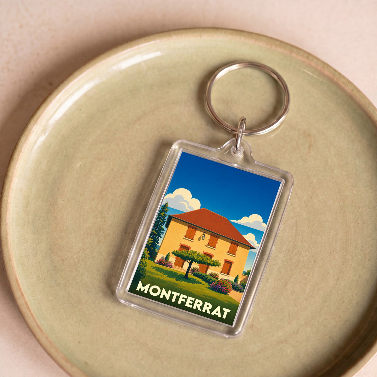 Porte-clés souvenir de la ville de Montferrat avec une illustration stylisée d'une maison provençale.
