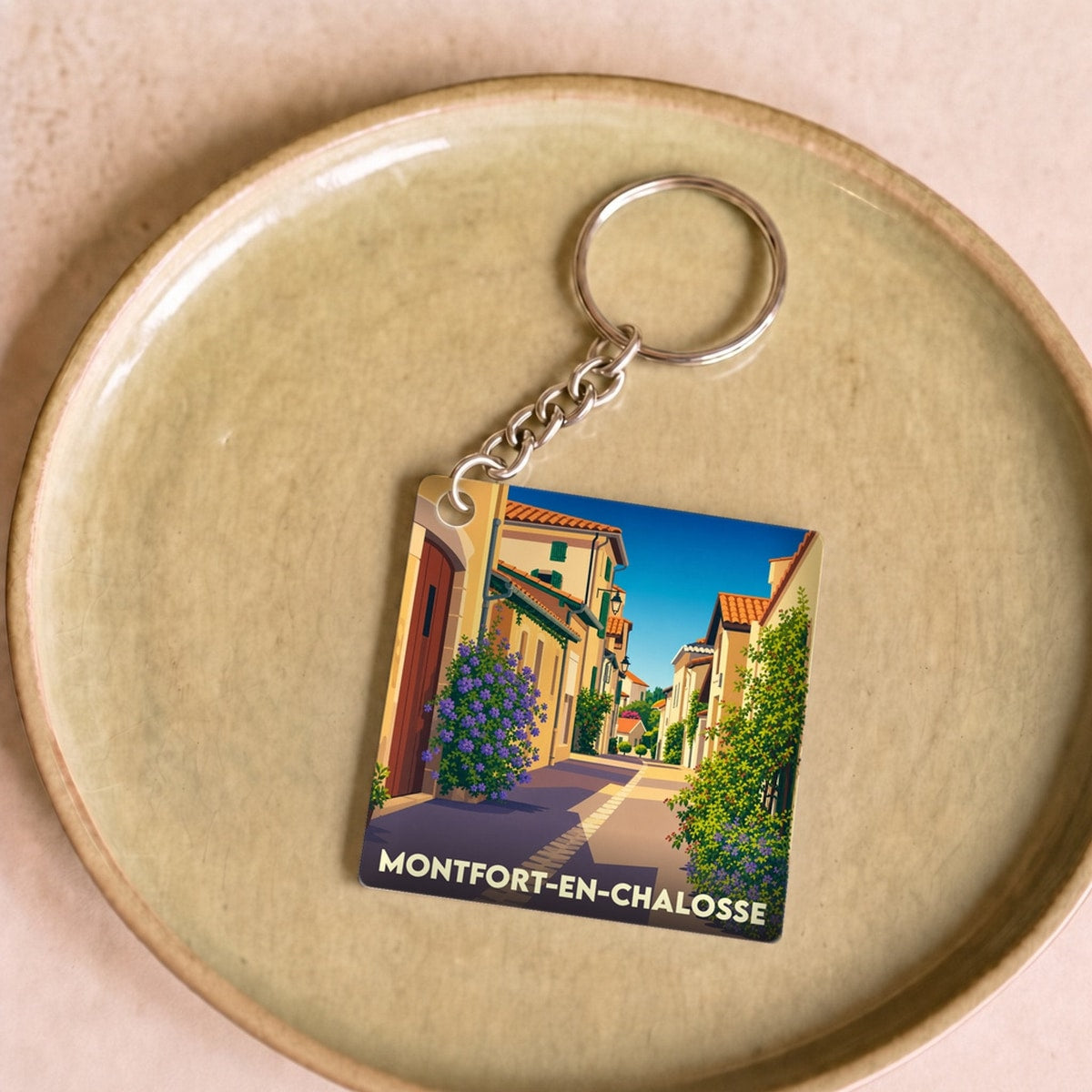 Porte-clés souvenir de la ville de Montfort-en-Chalosse avec une illustration stylisée.