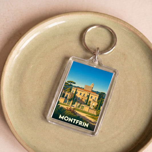 Porte-clés souvenir de la ville de Montfrin avec une illustration stylisée d'un château provençal.