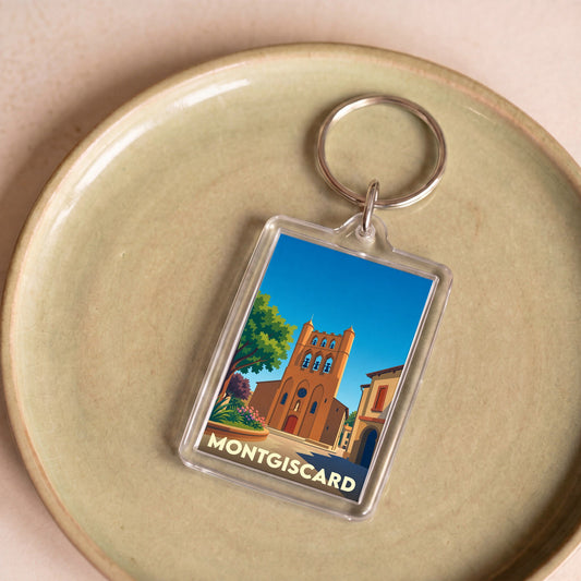 Porte-clés souvenir de la ville de Montgiscard avec une illustration stylisée de son église.