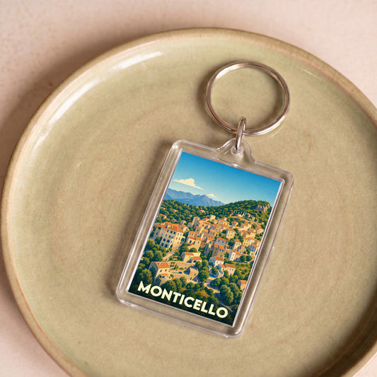 Porte-clés souvenir de la ville de Monticello avec une illustration stylisée d'un village corse.