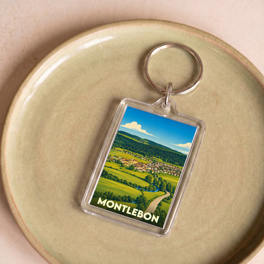 Porte-clés souvenir de la ville de Montlebon avec une illustration paysagère stylisée.
