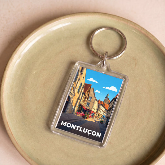 Porte-clés souvenir de la ville de Montluçon avec une illustration stylisée.