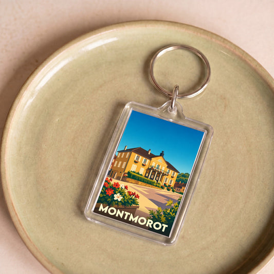 Porte-clés souvenir de la ville de Montmorot avec une illustration stylisée d'un bâtiment historique.