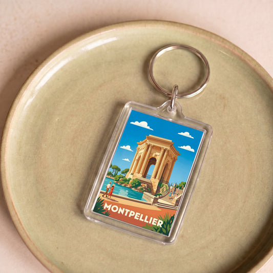 Porte-clés souvenir de la ville de Montpellier avec une illustration stylisée.
