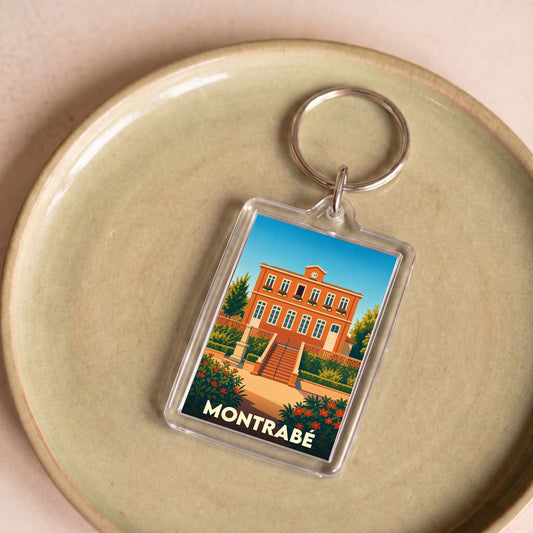 Porte-clés souvenir de la ville de Montrabé avec une illustration stylisée de sa mairie.